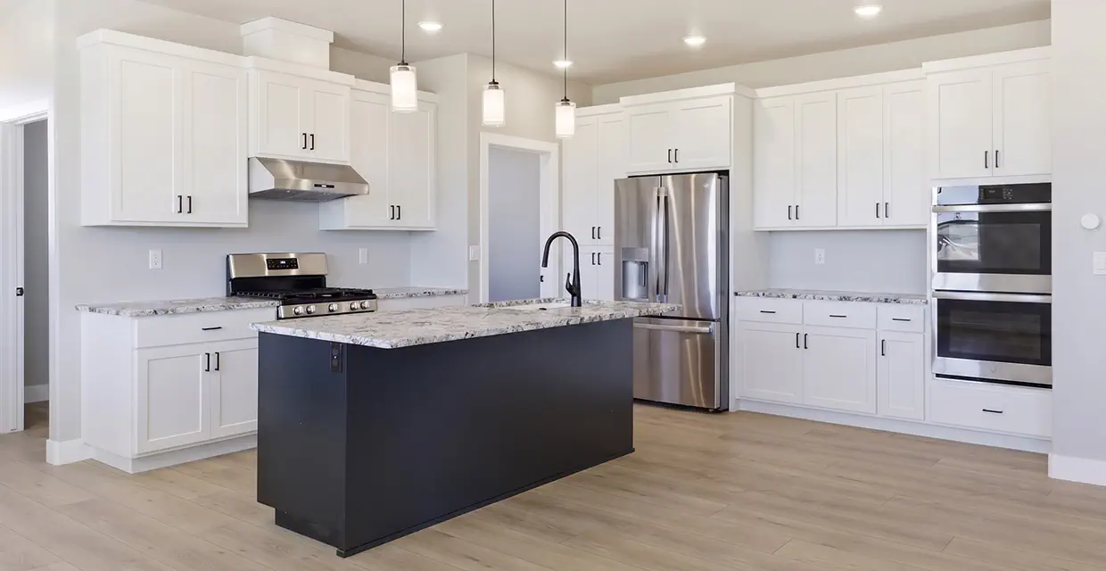 Westview Ridge kitchen with double wall ovens, stainless refrigerator, navy island and luxury vinyl plank floors